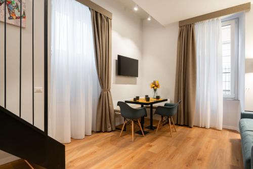 a living room with a table and chairs at Major House - Luxury Apartments in Rome by Hostand in Rome