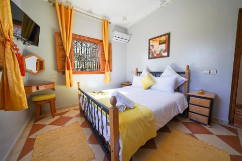 a bedroom with a bed and a window at Villa Timskrine - Panoramic Mountains View in Marrakesh