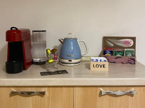 a kitchen counter with a coffee maker and a blender at Grazioso monolocale a Pomezia in Pomezia
