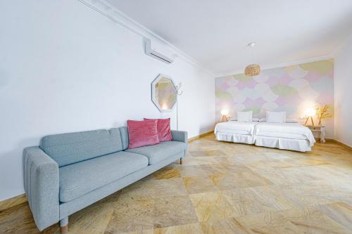 a living room with a couch and two beds at Labreña Hotel in Los Caños de Meca