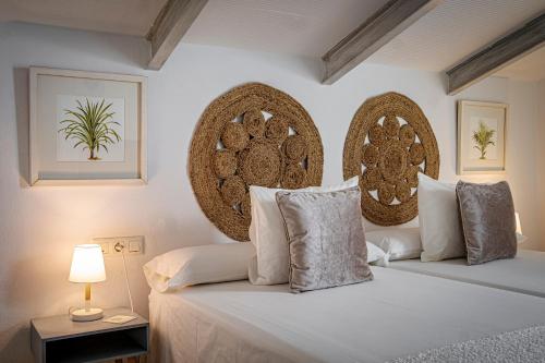 a bedroom with a bed with two pillows at Labreña Hotel in Los Caños de Meca