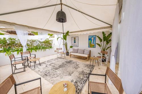 a living room with a tent with tables and chairs at Labreña Hotel in Los Caños de Meca