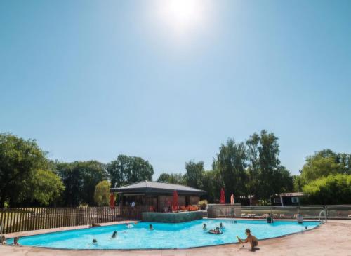 a group of people in a pool at a park at pipowagen met prive Hot tub in Lanaken