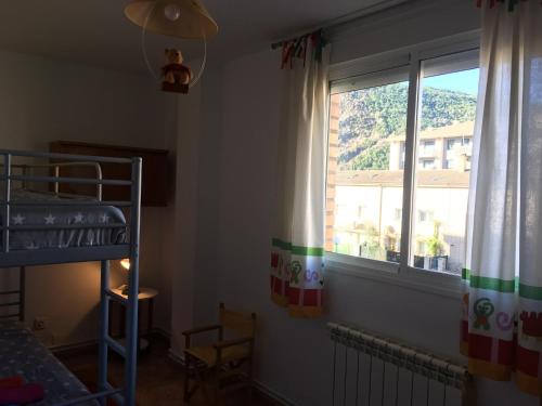 a bedroom with a bunk bed and a window at Pirineo Aragonés. Casa La Paz in Sabiñánigo