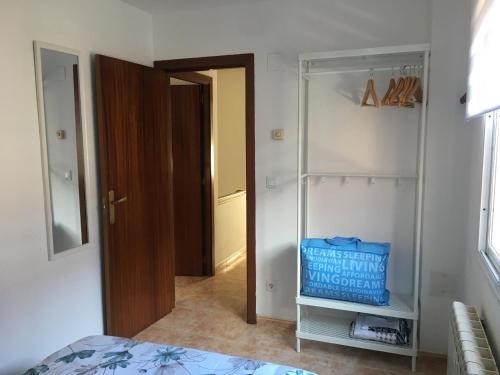 a bedroom with a bed and a closet with a blue bag at Pirineo Aragonés. Casa La Paz in Sabiñánigo