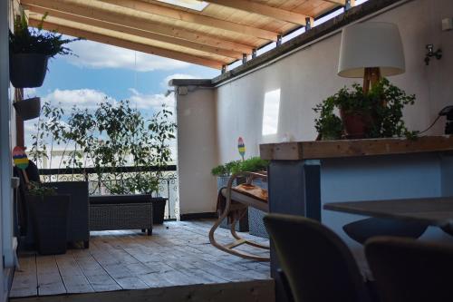a room with a balcony with a table and chairs at The Piedmont Gate, Walk to Metro, 2 Bedroom Apartment, Terrace, Baby Equipment, AC, Near Shopping Center in Collegno