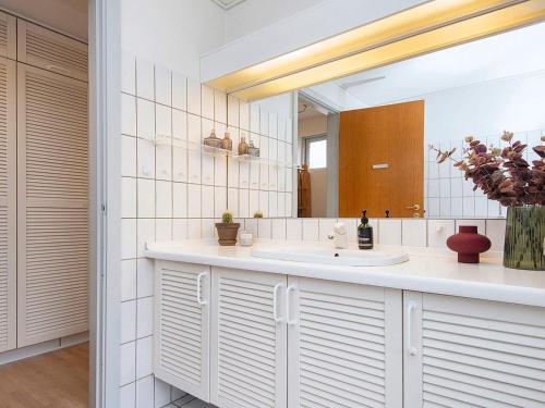 a bathroom with a sink and a mirror at Family-Friendly House by the Beach in Ebeltoft