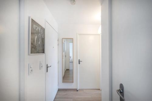 a hallway with white walls and white doors at Les Terrasses de Louise in Bordeaux