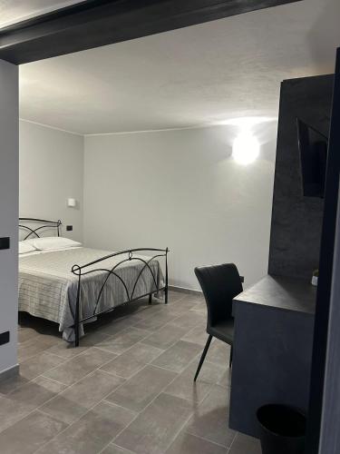 a bedroom with a bed and a chair in it at B&B Il Gelsomino in Fontanelle di Roccabianca