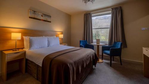 a hotel room with a bed and a window at The Tarbet Hotel in Tarbet