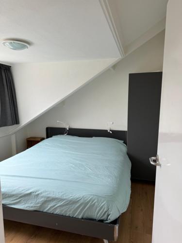 a bedroom with a bed in a room at Guesthouse West in Noordwijk