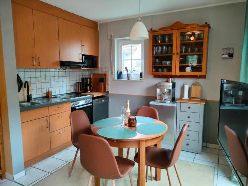 a kitchen with a table and chairs in it at Kleine Ferienoase am Plauer See in Funfseen