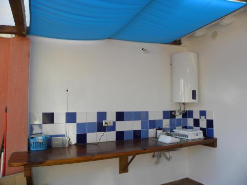 a kitchen with a sink and a blue ceiling at Casa do Mar in Figueira da Foz