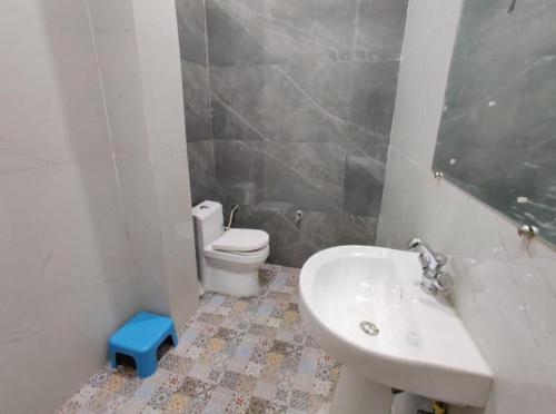 a bathroom with a white toilet and a sink at HOTEL HIVIN AND PEANCE - TOP RATED AND SERCH PROPERTY AMRITSAR in Amritsar