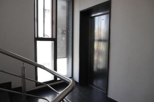 a staircase leading to a door in a room at HSM Grand Inn, Chittoor in Chittoor