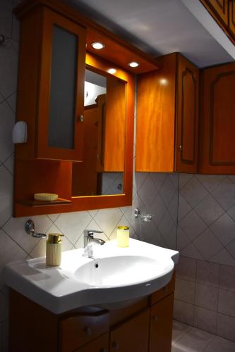 a bathroom with a white sink and a mirror at Casa Valesa in Skala Sotiros