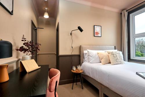 a bedroom with a bed and a desk and a bed at Settle in Winchester - Stylish Self Check-In Rooms in Winchester