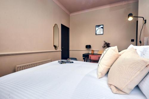 a bedroom with a bed with white sheets and pillows at Settle in Winchester - Stylish Self Check-In Rooms in Winchester