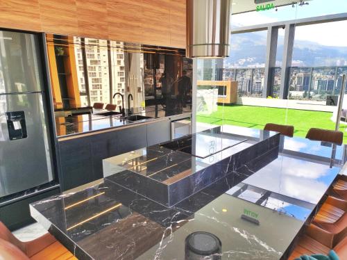 a kitchen with a glass counter top and a large window at Republica del Salvador Coliving Ecuador XOE in Quito