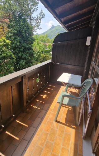 a patio with a table and a chair on a balcony at ciao-aschau FeWo Fey in Aschau