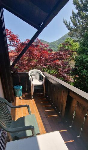 a porch with a bench and a table and chairs at ciao-aschau FeWo Fey in Aschau
