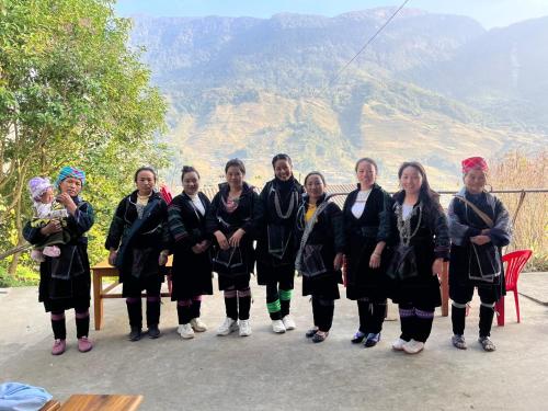 a group of women posing for a picture in the mountains at Sa Moc - La Maison House & Bungalow in Sa Pa