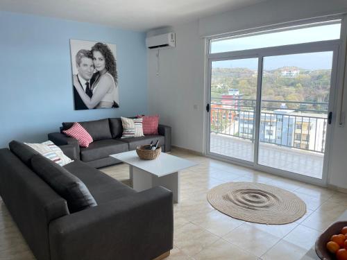 a living room with a couch and a table at Beachfront Marilyn in Durrës