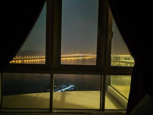a view of a bridge from a window at Invincible Seaview Vacation Condo 3R3B 8Pax in Bayan Lepas