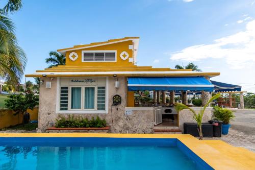 a house with a swimming pool in front of a house at Casamares Private Room Mar with Pool and Jacuzzi 5 min to Boqueron and Beaches in Cabo Rojo