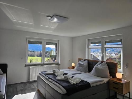 a bedroom with a large bed with two windows at Appartment Jasmin in Liezen