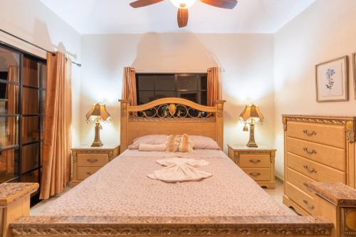 a bedroom with a large bed and two dressers at Villa downtown jarabacoa in Jarabacoa