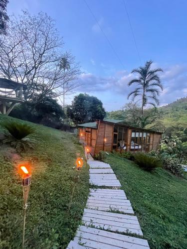 a path leading to a house with lights on it at Home Boutique Natural Paradise in La Vega