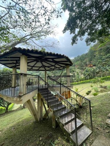 a structure with a staircase and an umbrella at Home Boutique Natural Paradise in La Vega