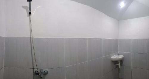 a bathroom with a shower and a sink at Bayan Exotic Homestay in Senaru