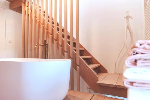 a bathroom with a staircase with towels on the floor at demimaisons in Esneux