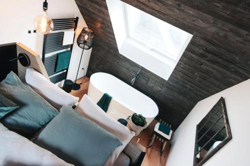 an overhead view of a living room with a couch and a window at demimaisons in Esneux