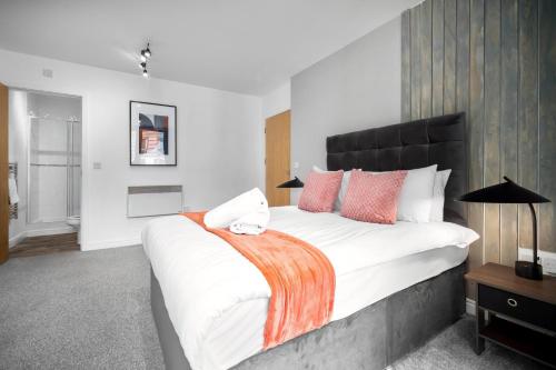 1 dormitorio con 1 cama blanca grande con almohadas de color naranja en Luxury City Centre 2 Bedroom Apartment - Secure Parking - Balcony - Top Rated - 377P en Birmingham