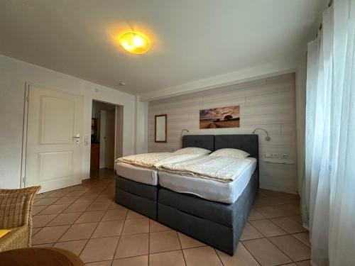 a bedroom with a large bed in a room at Pension Schramm in Karlsruhe