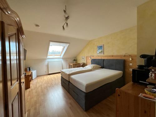 a bedroom with a large bed and a window at Pension Schramm in Karlsruhe