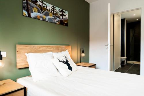 a bedroom with a large bed with a white bedspread at Les Terrasses du Noirmont 1 in Les Rousses