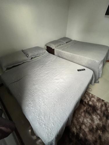 two beds sitting next to each other in a room at Muito Confortável AP203p in Rio de Janeiro