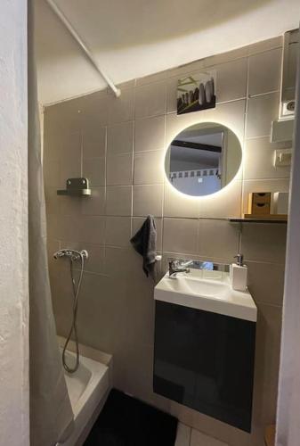 une petite salle de bain avec un lavabo et un miroir dans l'établissement Studio avec extérieur, à Marseille