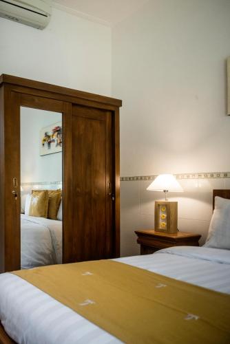 Ένα ή περισσότερα κρεβάτια σε δωμάτιο στο The Cozy Haven Sanur
