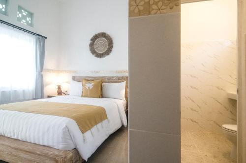 Ένα ή περισσότερα κρεβάτια σε δωμάτιο στο The Cozy Haven Sanur