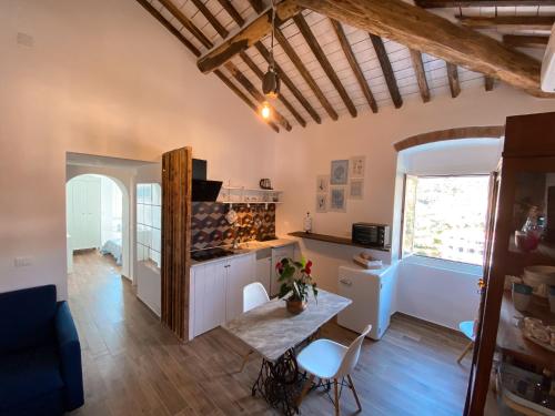 a kitchen with a table and chairs in a room at Casa Angè - Lerici, Golfo dei Poeti in Lerici