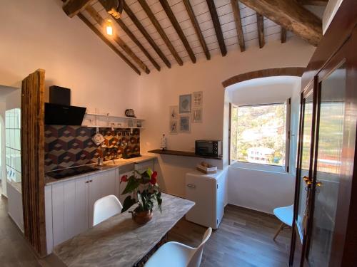 a kitchen with a table and chairs and a window at Casa Angè - Lerici, Golfo dei Poeti in Lerici