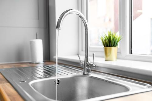 a kitchen sink with a faucet and a window at Modern 2 Bedroom Apartment - Off-street Parking - Top Rated - 1aS in Amblecote