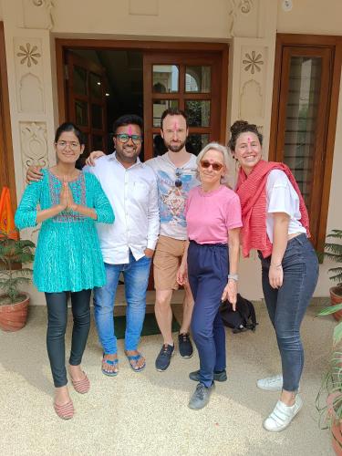 a group of people posing for a picture in front of a house at Gupta Vilas - A Boutique Homestay in Agra