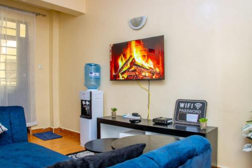 a living room with a fire painting on the wall at AirBnB in Nairobi