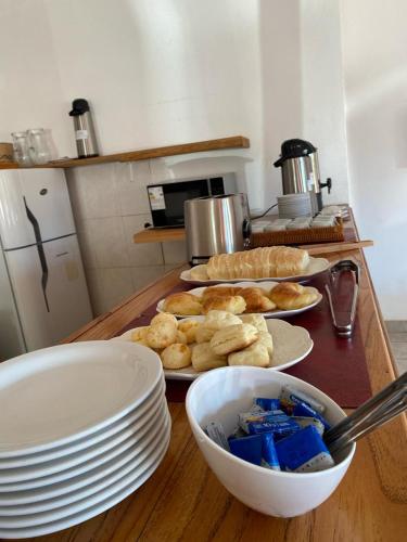 a table with plates and bowls of food on it at Hotel Puerto Libertad - Iguazú in Puerto Libertad
